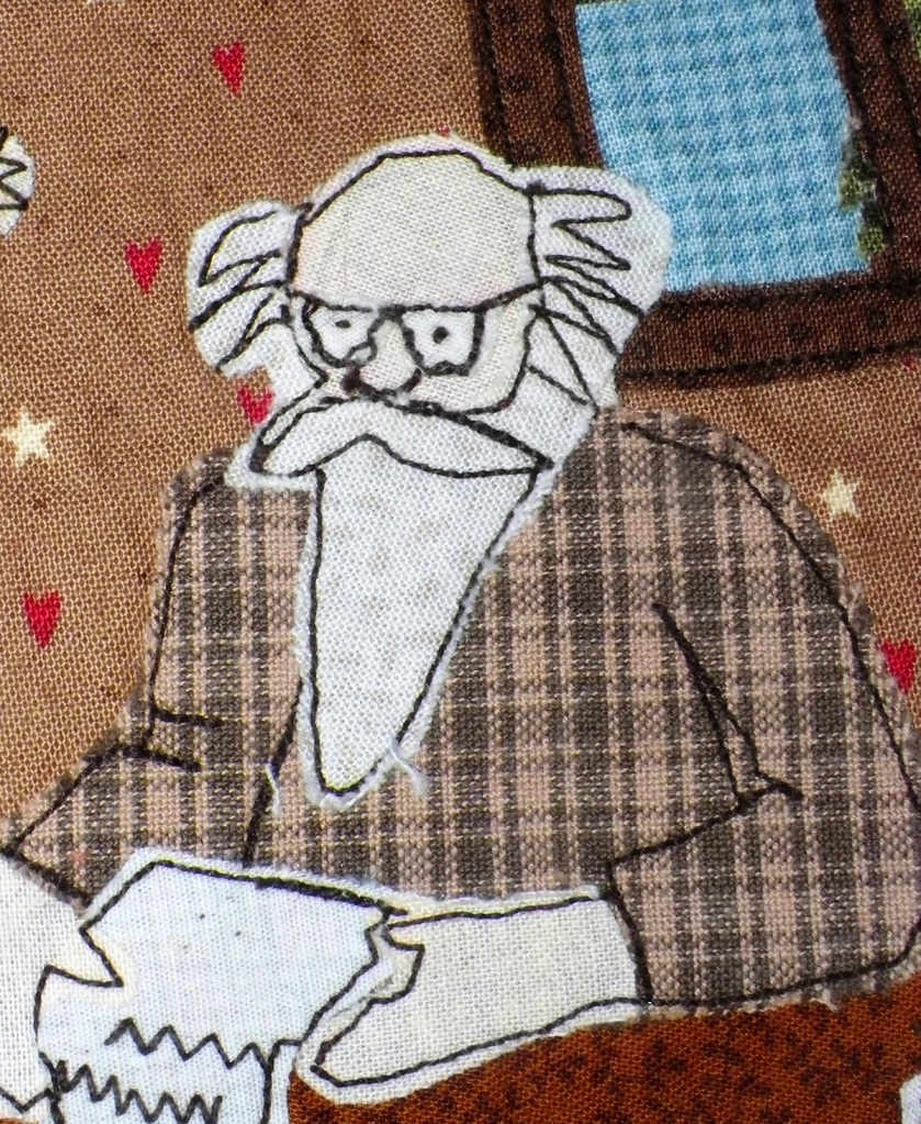 livre textile Le Village du père Noël
appliqué collé et broderie free motion